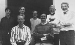 black and white group photo from 1995. There are 7 men featured