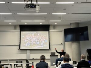 a man is presenting powerpoint slides to a small audience