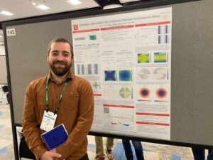 a man stands in front of a scientific poster